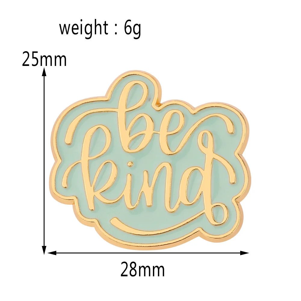 Be Kind enamel pin features gold cursive lettering on a mint green background with gold edging. This sage pin measures 25mm tall by 28mm wide and weighs 6g.