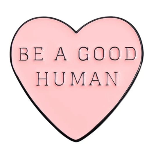 Pnk heart enamel pin features a bold black outline and “BE A GOOD HUMAN” in uppercase black letters—a positive reminder you can wear daily.