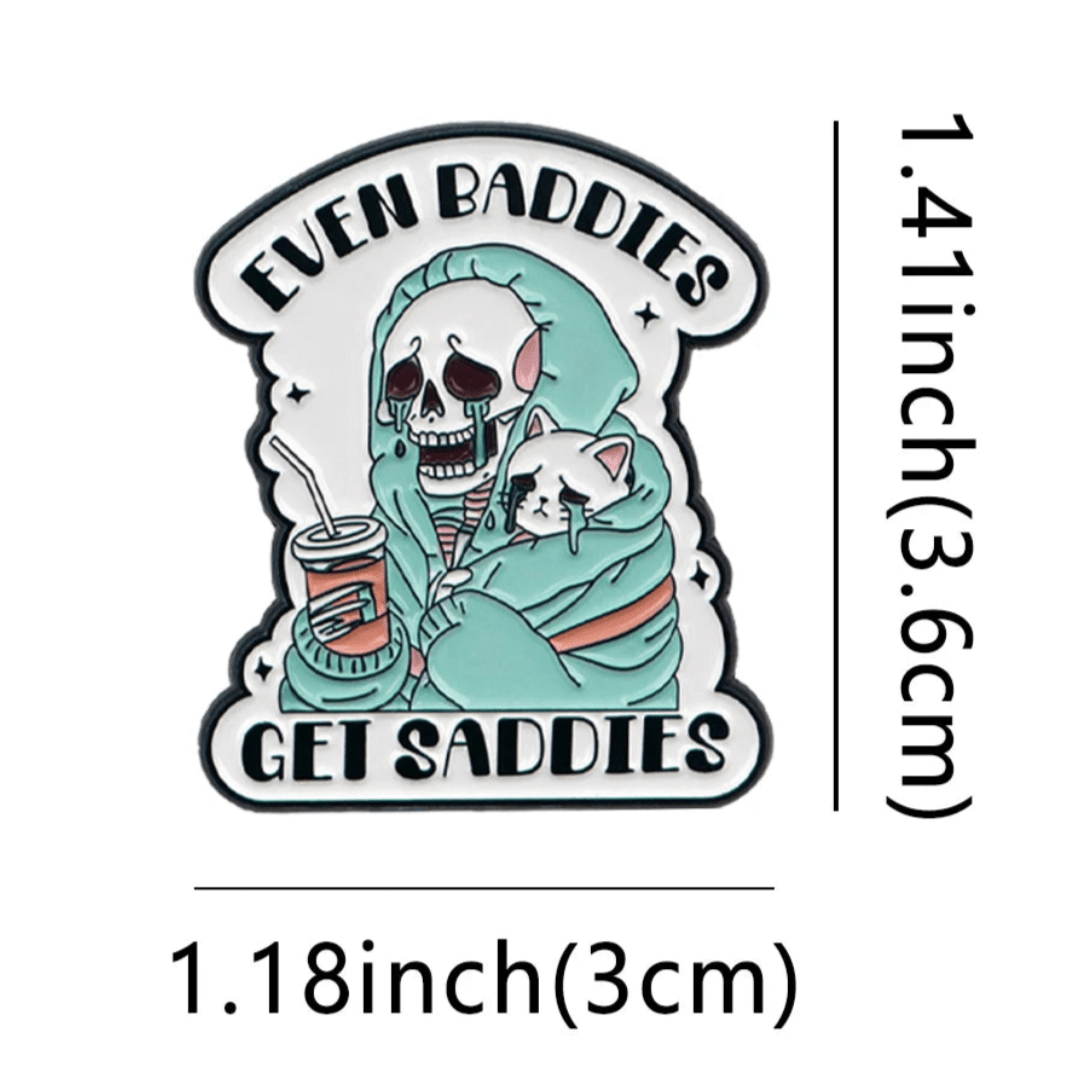 Show off your love for true crime with this cat pin featuring a skeleton in a green hoodie holding a drink and a sad white cat, plus the text EVEN BADDIES GET SADDIES. Measures 1.41 tall x 1.18 wide.