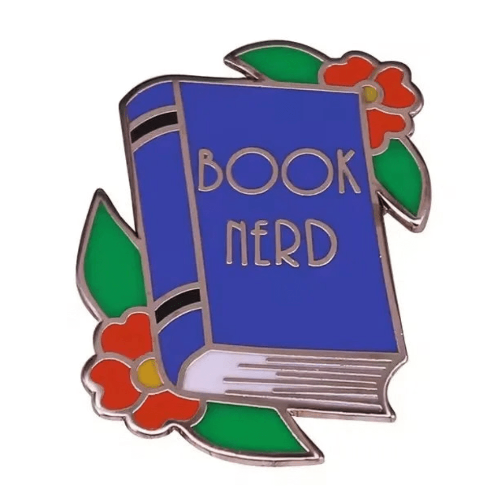 A blue enamel library pin shaped like a book with BOOK NERD on the cover, decorated with red flowers and green leaves perfect for book lover gifts or to add to your collection of book enamel pins.