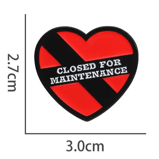 Show your heart is closed for maintenance with My Cutesy Era’s red heart enamel pin (2.7 cm x 3.0 cm) featuring a black diagonal stripe and “CLOSED FOR MAINTENANCE” in white text across the center.