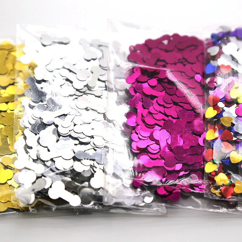Four clear Kiss Me Later bags filled with gold, silver, pink, and purple penis-shaped confetti—perfect for adding cheeky adult fun to your celebration. Each bag is neatly arranged side by side on a white background.