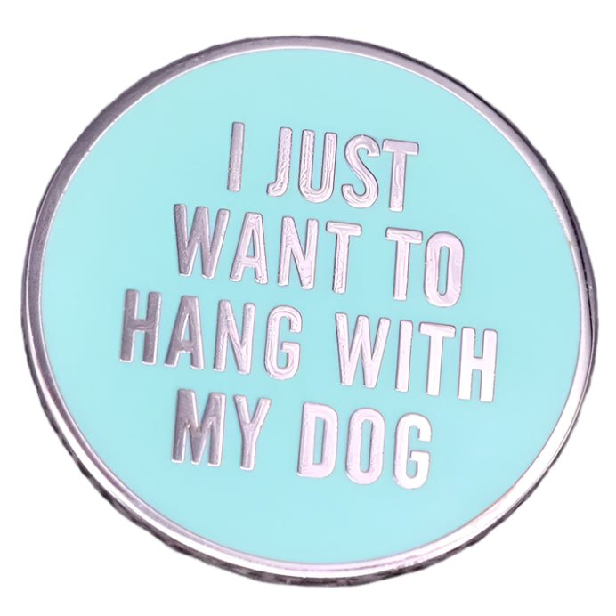 My Cutesy Eras blue enamel pin features silver text that says I JUST WANT TO HANG WITH MY DOG on a light blue background, adding a playful touch for dog lovers.