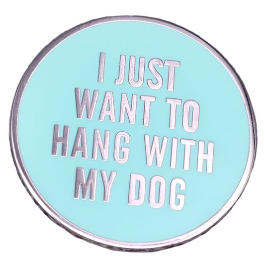 My Cutesy Eras blue enamel pin features silver text that says I JUST WANT TO HANG WITH MY DOG on a light blue background, adding a playful touch for dog lovers.
