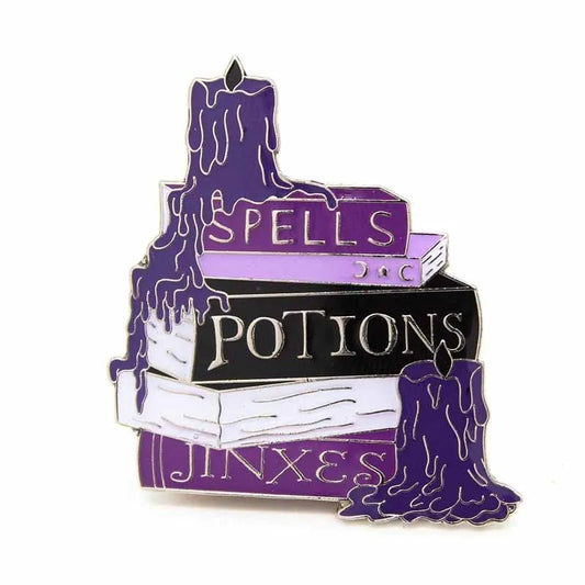 My Cutesy Era witchy enamel pin features three stacked books—SPELLS, POTIONS, JINXES—and two dripping purple candles, making it a perfect magical accessory for any collection.