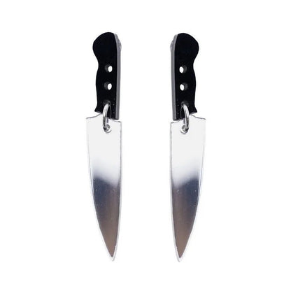 Kiss Me Later knife earrings feature kitchen knife shapes with black handles and silver blades, crafted from acrylic charms and shown side by side on a white background.