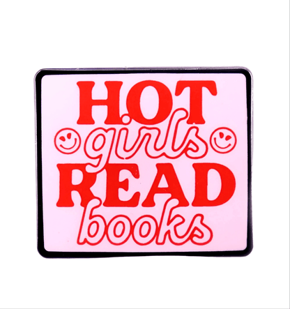 The Kiss Me Later rectangular enamel pin features a pink background, red HOT girls READ books text, and two smiley faces by girls. A stylish book lover accessory for readers.