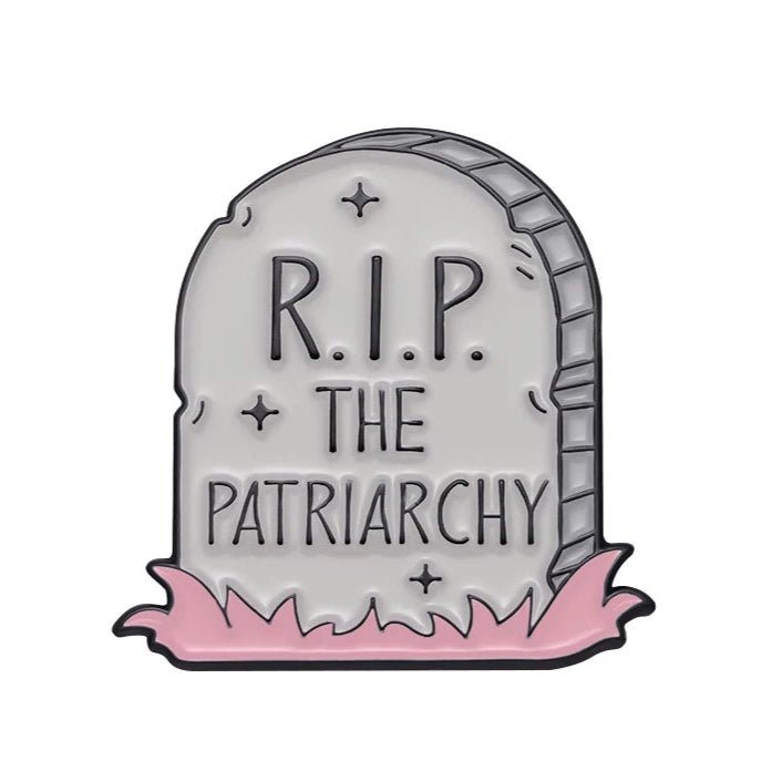 Patriarchy Tombstone enamel pin features R.I.P. THE PATRIARCHY in a cartoon style with pink grass—ideal for fans of feminist pins.