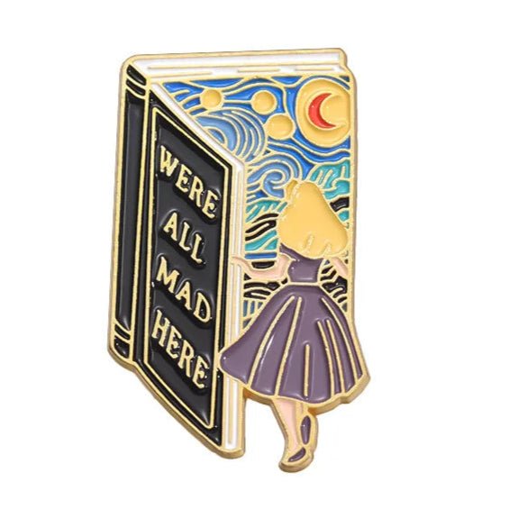 The My Cutesy Era enamel pin features a girl in a purple dress entering a "WE'RE ALL MAD HERE" book, with a vibrant sky, moon, and stars—an ideal whimsical gift for book lovers and unique accessory for any bookworm.