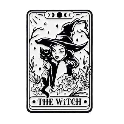 Black and white Kiss Me Later illustration featuring a woman in a witch hat holding a black cat, surrounded by flowers and leaves. THE WITCH text at the bottom adds a mystical, spooky vibe to this ornate design.