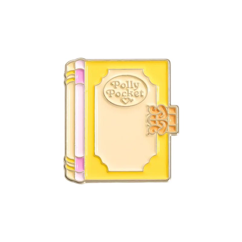 My Cutesy Era enamel pin: closed yellow book with pink spine, gold accents, and "Polly Pocket" on the cover in a decorative frame—perfect as a charming accessory or gift for book lovers and bookworms.