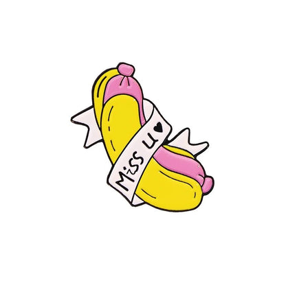 Cartoon-style yellow banana pin with pink tips and a white Miss U ribbon (with heart) is a cute pink and yellow accessory, perfect for anyone who loves Miss You pins. Displayed on a plain white background.