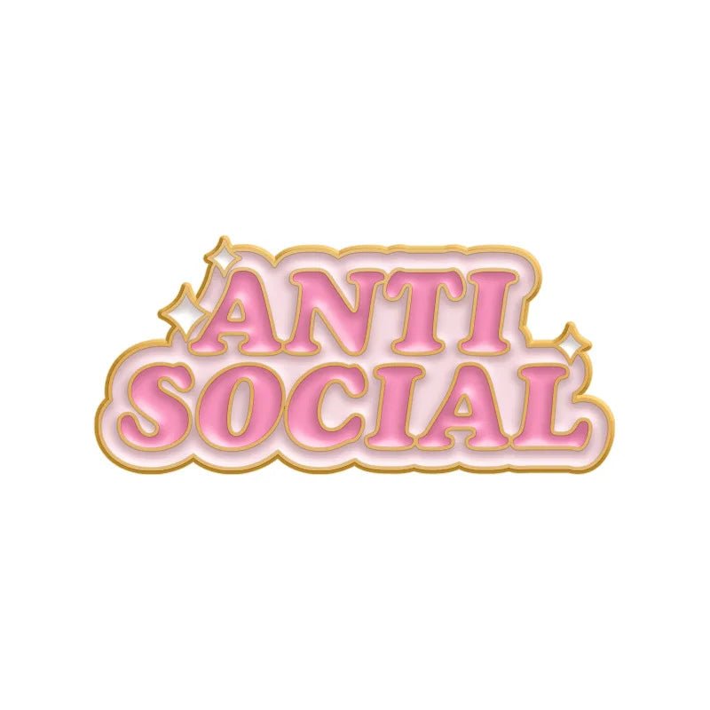 The My Cutesy Era pink and gold enamel pin features “ANTI SOCIAL” in bold uppercase letters, gold outline, and sparkling accents—a motivational mental health accessory for a unique statement.