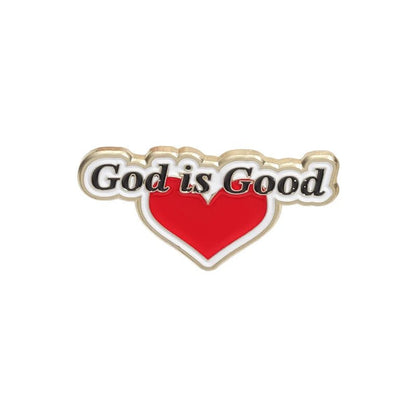 The Kiss Me Later pink enamel pin features God is Good in black and white lettering above a large red heart with a gold outline.