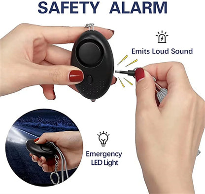 A black Kiss Me Later safety alarm device with a keychain is shown. One image shows it emitting a loud sound when the pin is pulled, and another shows it shining a bright LED light—perfect for outdoor adventures and personal safety.