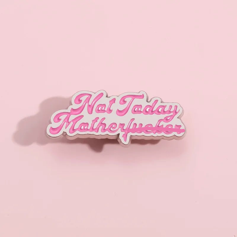 The My Cutesy Era enamel pin features “Not Today Motherfucker” in pink and white cursive on a light pink background. Perfect for Mean Girls fans, this sassy accessory adds attitude to your collection. Soft left shadow detail included.
