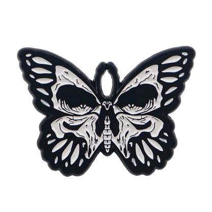 A Kiss Me Later butterfly illustration in black and white features a skull-shaped center on its wings, blending spooky vibes with intricate patterns for an eerie yet captivating design.
