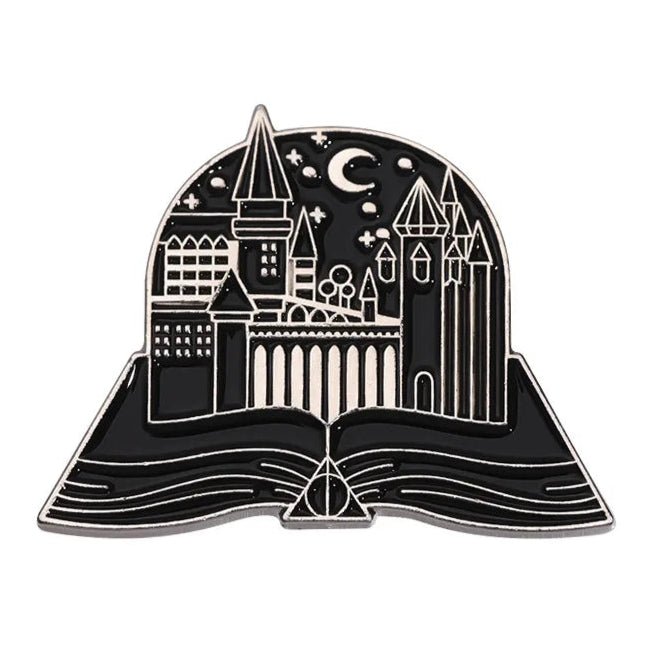 The My Cutesy Era black and silver enamel pin features an open book with a castle, stars, and crescent moon—a magical accessory for book lovers and the perfect gift for any bookworm’s collection.