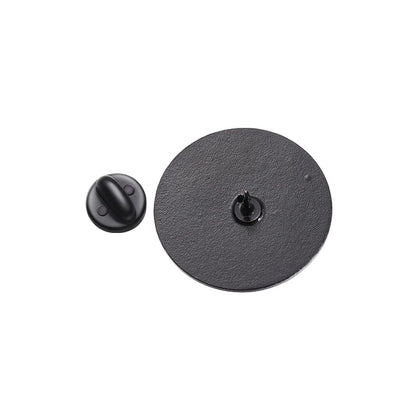 A round black enamel pin with its butterfly clutch backing detached on a white background. The pins textured back and point are visible—ideal as a cat feminist badge or for Cats Against Catcalls fans.