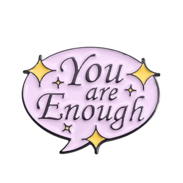 Introducing the Kiss Me Later limited edition enamel pin—a motivational accessory featuring a light purple speech bubble, You are Enough in black, and four small yellow stars to brighten your day.
