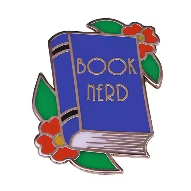 A blue Book Nerd book, surrounded by green leaves and red flowers, illustrated as a colorful enamel pin from My Cutesy Era—perfect for any book lover’s collection.
