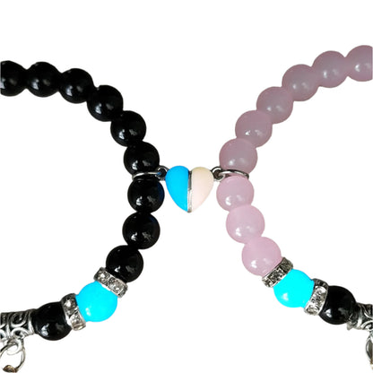 Two beaded magnetic heart bracelets with black, pink, and blue beads