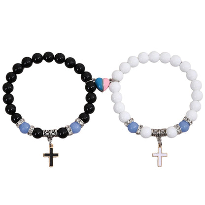Two beaded bracelets with cross charms and pink and blue magnetic heart charm