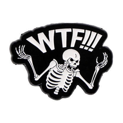 A cartoon skeleton from Kiss Me Later raises its hands with a confused, spooky look and bold white WTF!!! above its head on a black background.