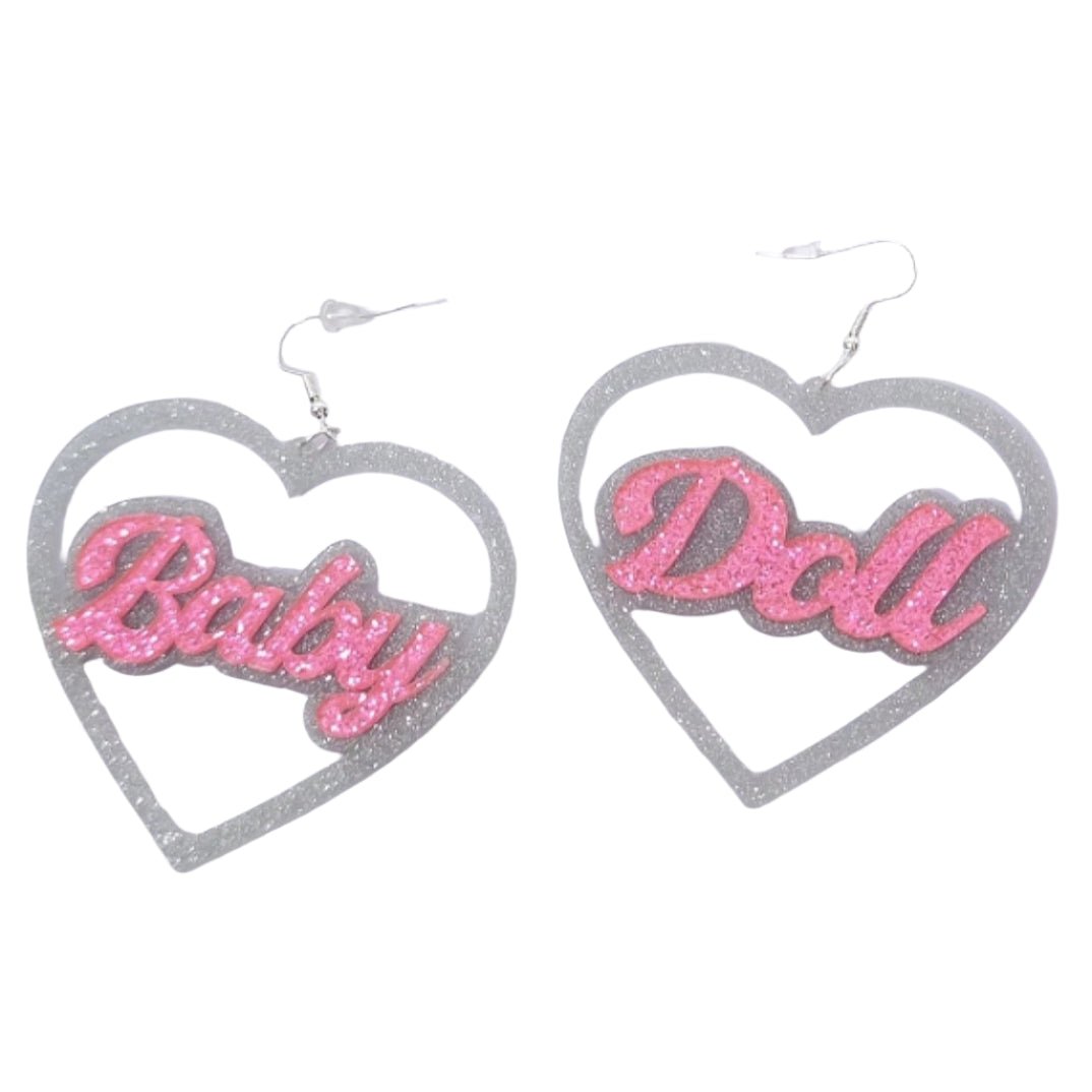 Heart-shaped earrings with 'Baby' and 'Doll' text 