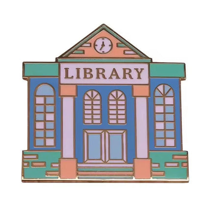 Library pin features large arched windows, double doors, a triangular roof with a clock, and LIBRARY above the entrance—perfect for book lovers or enamel pin collectors.