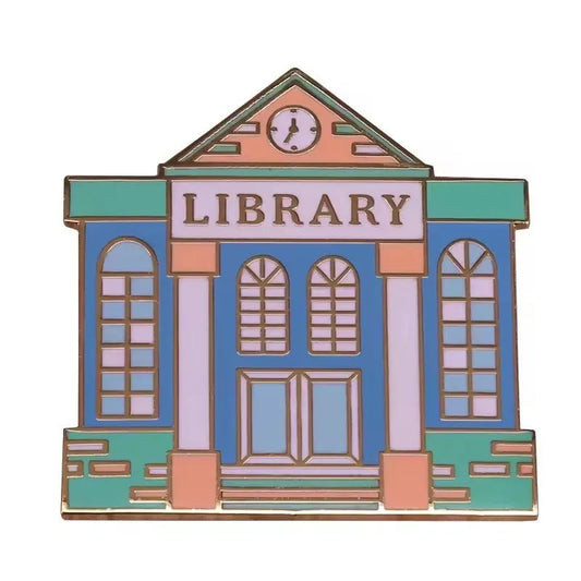 Library pin features large arched windows, double doors, a triangular roof with a clock, and LIBRARY above the entrance—perfect for book lovers or enamel pin collectors.