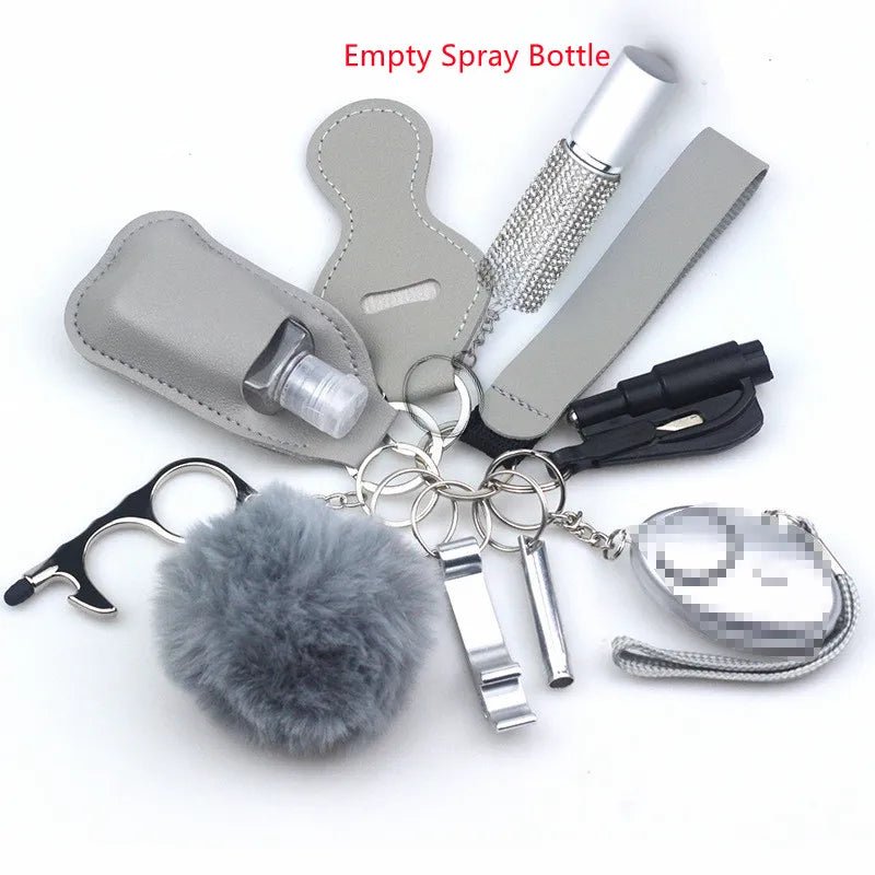 The Kiss Me Later keychain set includes gray personal safety essentials like a pom-pom, touch tool, no-touch door opener, empty spray bottle, whistle, mini flashlight, lip balm holder, and personal alarm—great for outdoor adventures.