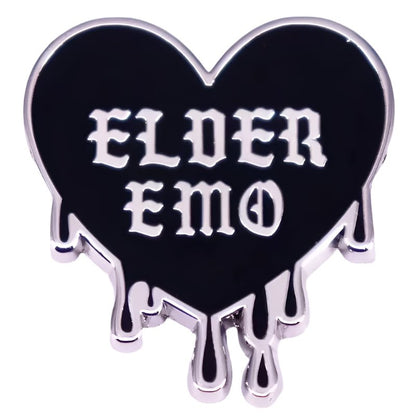 black heart-shaped pin with silver trim and dripping edges features bold, gothic white ELDER EMO text—perfect to pair with your favorite Gothic spider pin.