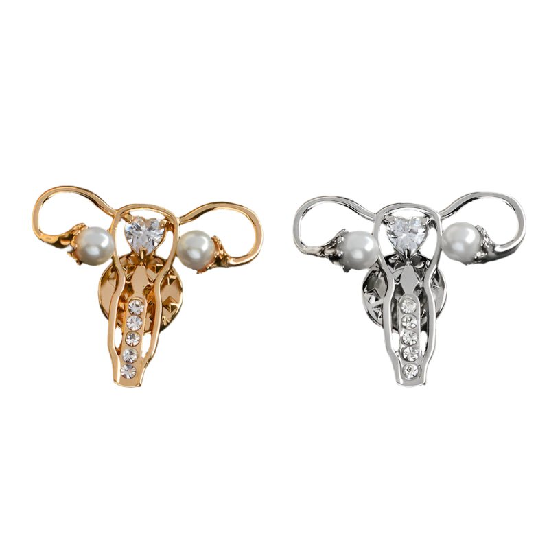 My Cutesy Era’s set of two uterus ovary pins—one gold, one silver—features pearls and clear gemstones for a bold feminist statement gift.