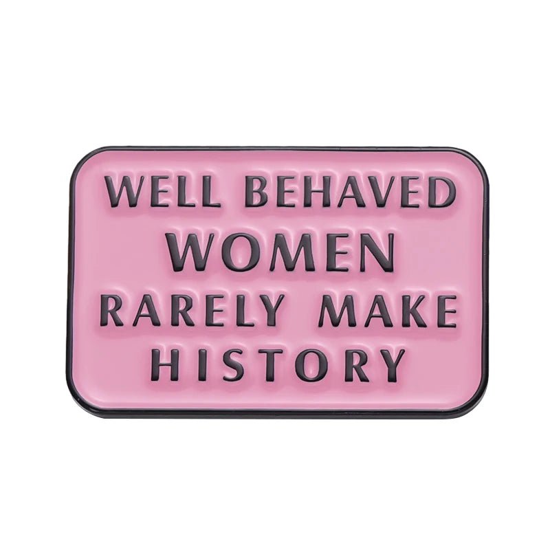 A pink rectangular sign with raised black letters reading WELL BEHAVED WOMEN RARELY MAKE HISTORY—the perfect match for your favorite Feminist Pins.