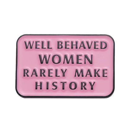 A pink rectangular sign with raised black letters reading WELL BEHAVED WOMEN RARELY MAKE HISTORY—the perfect match for your favorite Feminist Pins.