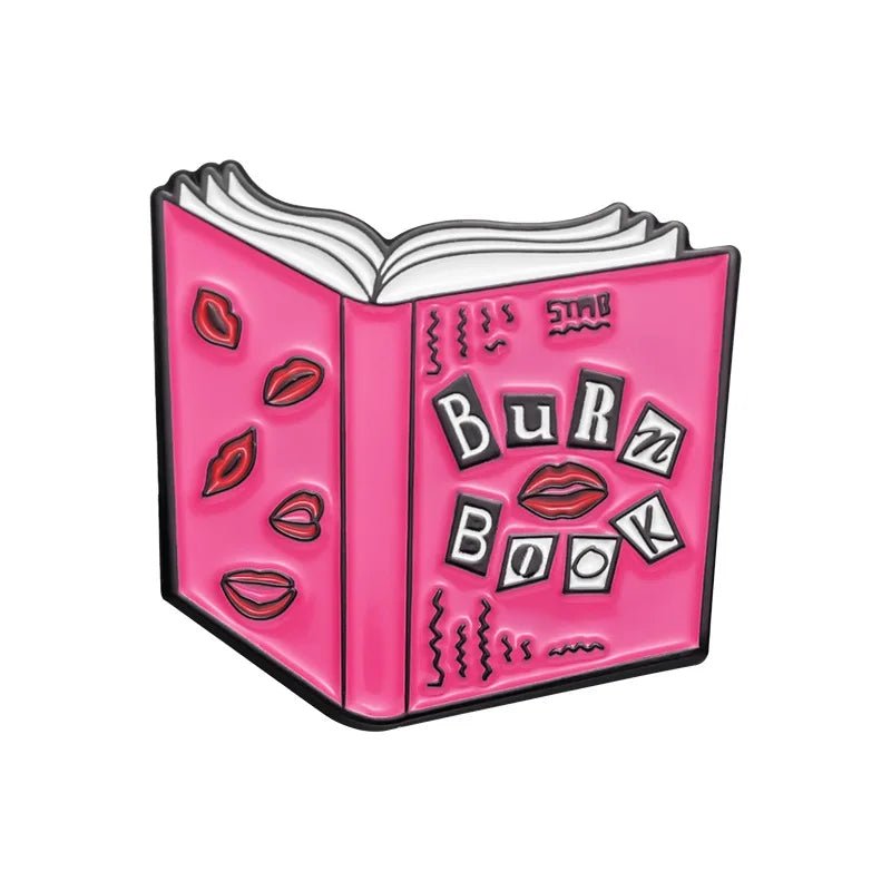 Illustration of an open pink book titled Burn Book with ransom note-style letters, red lipstick kiss marks, and a pink rollerskate pin—perfect enamel pin for Mean Girls fans from My Cutesy Era