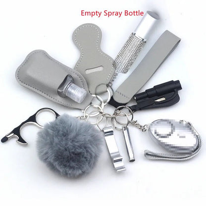 The Kiss Me Later keychain set includes a fuzzy pom-pom, gray spray bottle case, whistle, flashlight, touch tool, silver container, and small alarm with a pixelated label—perfect for outdoor adventures and personal safety.
