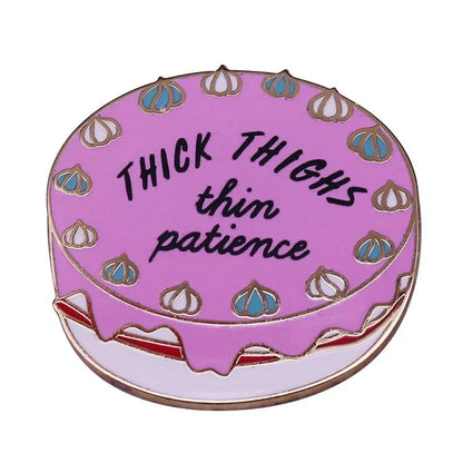 TheMy Cutesy Era pink frosted vintage cake pin features blue and white decorations, black “THICK THIGHS thin patience” lettering—perfect for sassy style fans and enamel pin collectors.