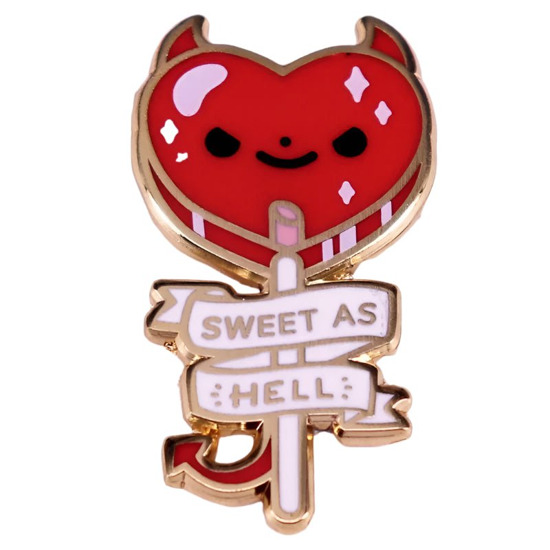 The My Cutesy Era Sweet As Hell enamel pin features a red heart-shaped devil with horns, a smiling face, gold outlines, a playful tail, and a white banner reading Sweet As Hell in gold.