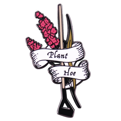 The My Cutesy Era enamel pin features pink flowers, a gardening hoe, and a white ribbon with Plant Hoe—a charming addition to any floral pin collection.