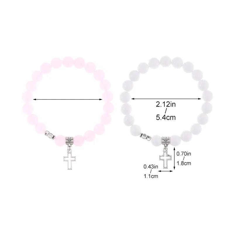Two My Cutesy Era crystal bead bracelets—one pink, one white—feature silver Cross charms. Each Christian bracelet has a 2.12-inch (5.4 cm) diameter, with cross charm size precisely detailed for added style.