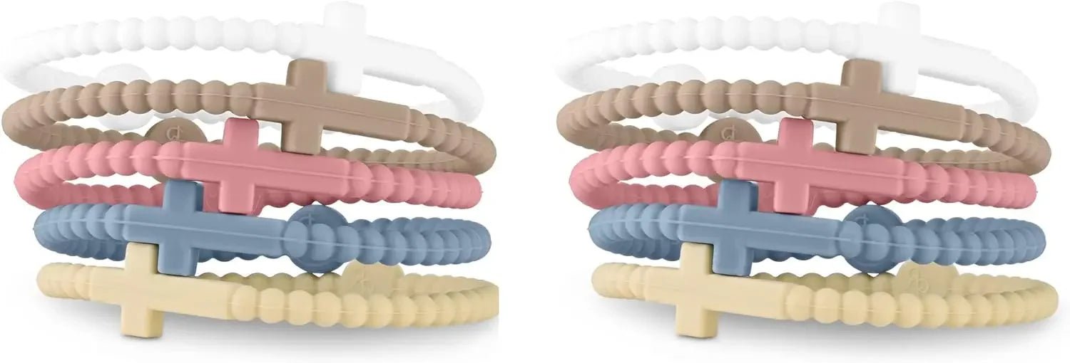 Six Kiss Me Later silicone Cutie Bracelets with crosses in white, brown, pink, blue, tan, and beige—stacked in two sets on a white background—make a charming reminder of Jesus’ love.