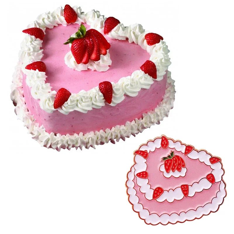 A heart-shaped pink cake by My Cutesy Era, topped with white frosting and a central strawberry cluster, sits beside a matching heart-shaped board with a vintage cake pin accent and playful strawberry pattern.