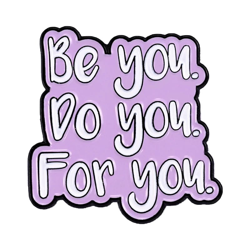 enamel pin features bold white text, Be you. Do you. For you, on a light purple background with a cute heart accent, making this empowering self-love accessory playful and stylish.