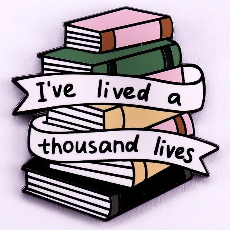 Enamel pin features a stack of colorful books with a ribbon that reads Ive lived a thousand lives. Perfect for romance readers and book lovers who love collecting unique badges.