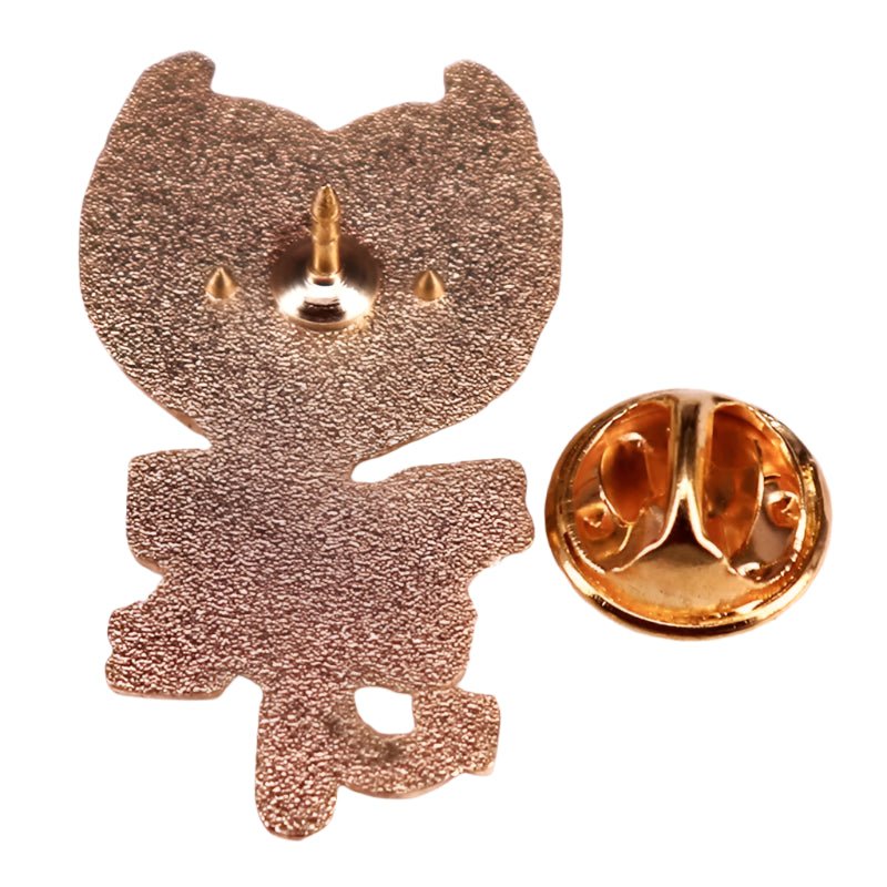 A gold metal pin by Kiss Me Later, shaped like a sitting cat viewed from behind, comes with a round butterfly clutch—an adorable addition to your enamel pin collection.