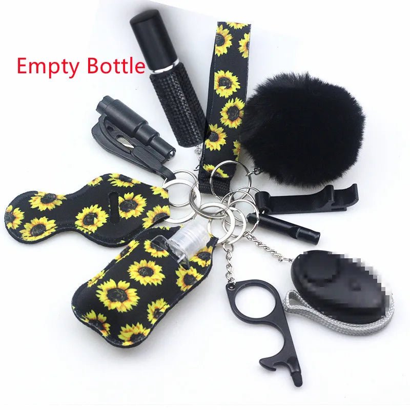 The Kiss Me Later sunflower-patterned keychain set includes personal safety accessories such as an empty bottle, whistle, pom-pom, door opener tool, alarm, car escape tool, and eye mask—ideal for outdoor adventures.