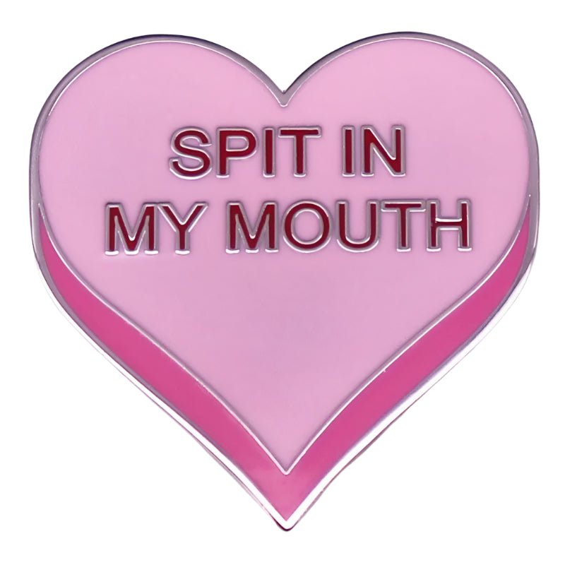 A pink love heart enamel pin by My Cutesy Era, featuring bold SPIT IN MY MOUTH text across the center—an eye-catching addition to your collection.