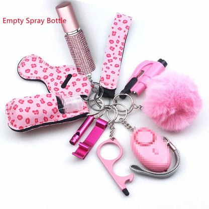 The Kiss Me Later keychain set includes pink personal safety accessories: pom-pom, safety alarm, no-touch tool, lipstick, empty spray bottle, lip balm holder, and chapstick holder—ideal for outdoor adventures and daily use.